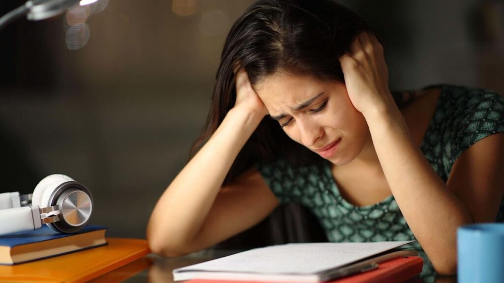 Student studying alone for JEE and NEET preparation at home highlighting the mental health impact of dummy school admissions.
