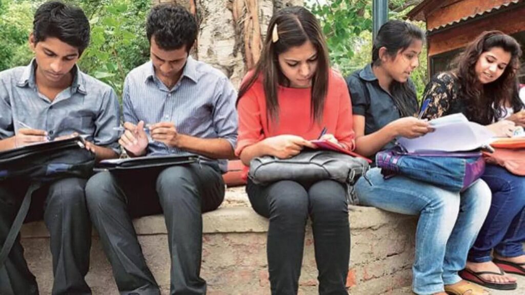 Students learning in a small batch coaching classroom with personalized teacher attention