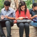 Students learning in a small batch coaching classroom with personalized teacher attention