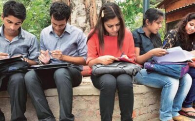 Students learning in a small batch coaching classroom with personalized teacher attention